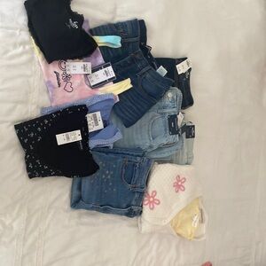 Bundle of 11 clothing items. Jeans, tank top, short sleeve tops from Brandy.